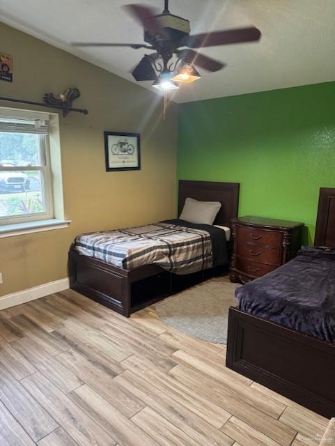 bedroom featuring ceiling fan and light wood-type flooring