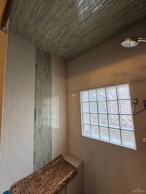 bathroom with brick ceiling and a shower