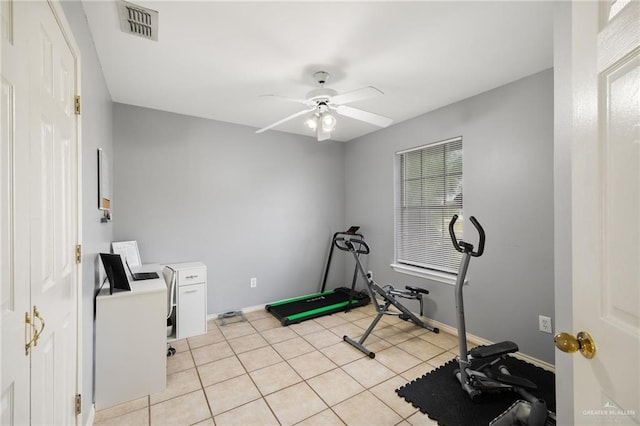 workout room featuring baseboards, a ceiling fan, visible vents, and light tile patterned floors