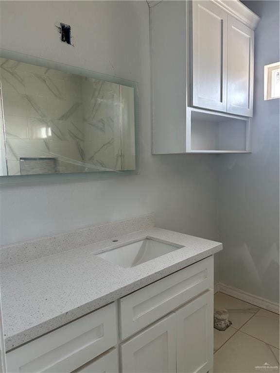 bathroom with baseboards and vanity