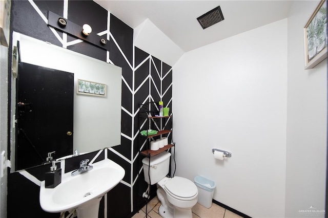 bathroom featuring toilet, tile patterned floors, and sink