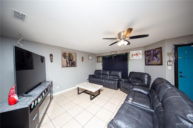 tiled living room with ceiling fan