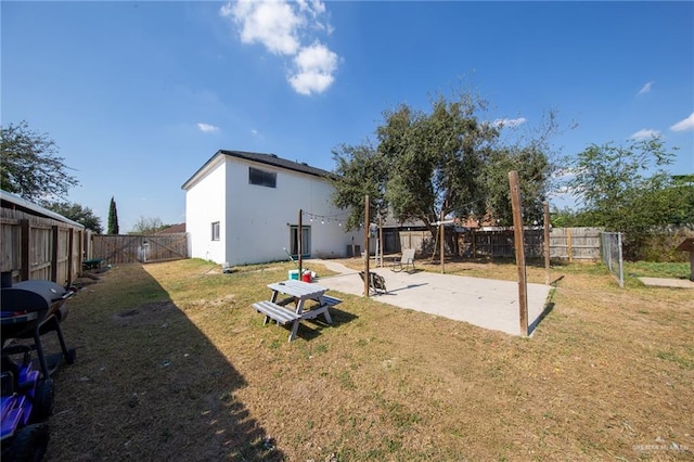 back of property featuring a lawn and a patio