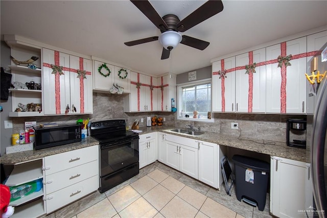 kitchen with backsplash, white cabinetry, sink, and black appliances