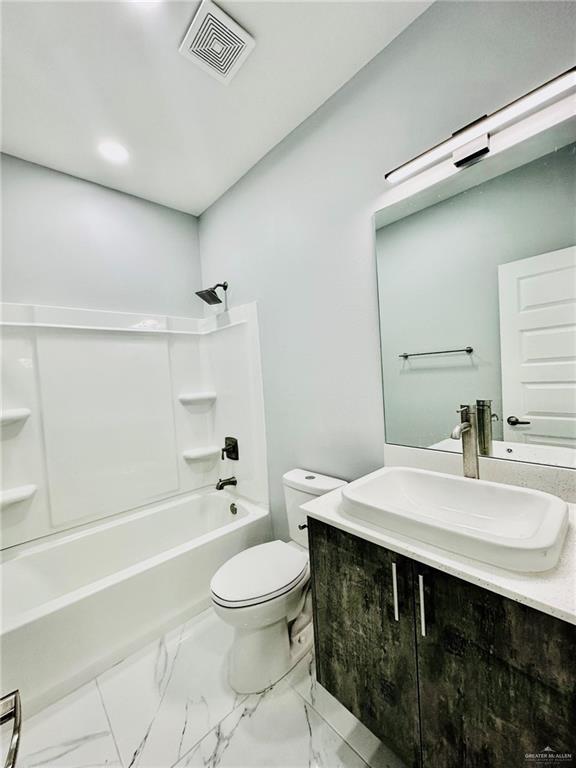 full bathroom featuring vanity, shower / washtub combination, and toilet