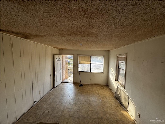 spare room with a textured ceiling