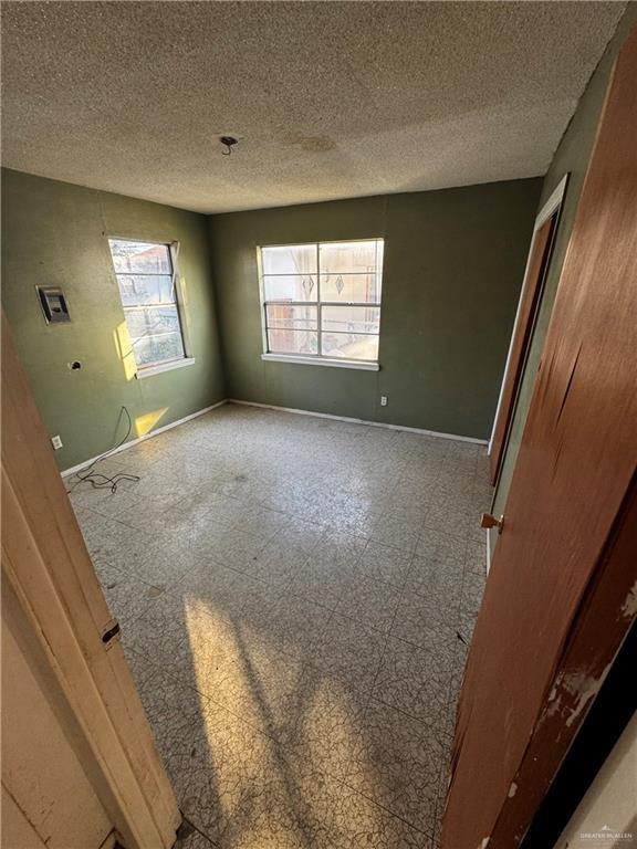 empty room featuring a textured ceiling