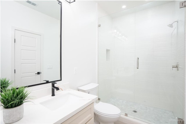 bathroom featuring vanity, toilet, and an enclosed shower