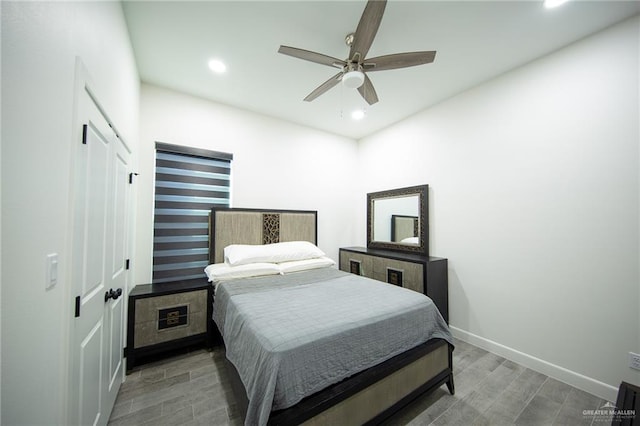 bedroom with recessed lighting, a closet, baseboards, and wood finished floors