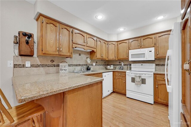 517 Gemini St, Mission, TX 78572 - kitchen featuring white appliances, a sink, a peninsula, light countertops, and tasteful backsplash