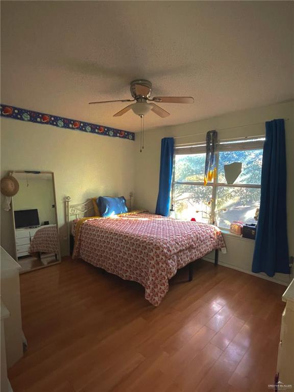 bedroom with hardwood / wood-style flooring