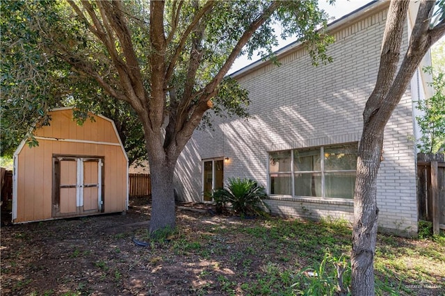 3301 Princeton Ave, Mcallen, TX 78504 - back of house featuring brick siding, a storage shed, fence, and an outdoor structure