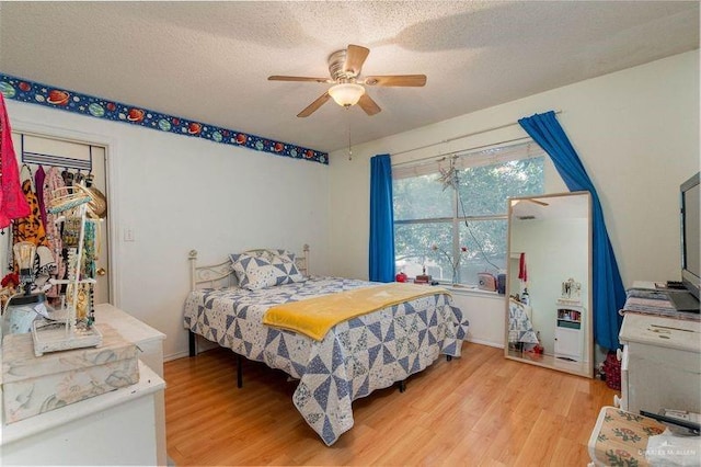 3301 Princeton Ave, Mcallen, TX 78504 - bedroom with light wood-type flooring, a textured ceiling, a ceiling fan, and baseboards