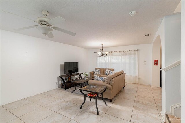 3301 Princeton Ave, Mcallen, TX 78504 - living room with arched walkways, light tile patterned floors, ceiling fan, a textured ceiling, and a chandelier