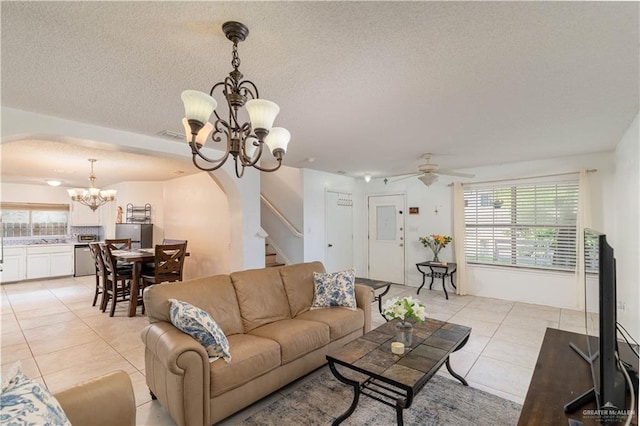 3301 Princeton Ave, Mcallen, TX 78504 - living room featuring a chandelier, light tile patterned flooring, arched walkways, stairway, and a textured ceiling
