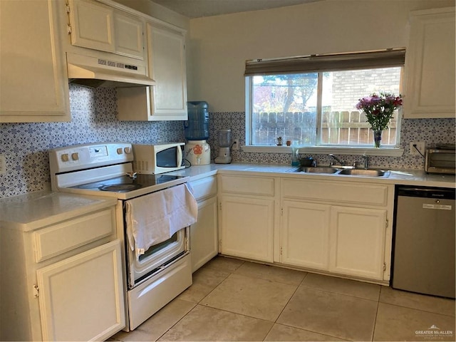 kitchen with white cabinetry, white appliances, sink, and light tile patterned floors