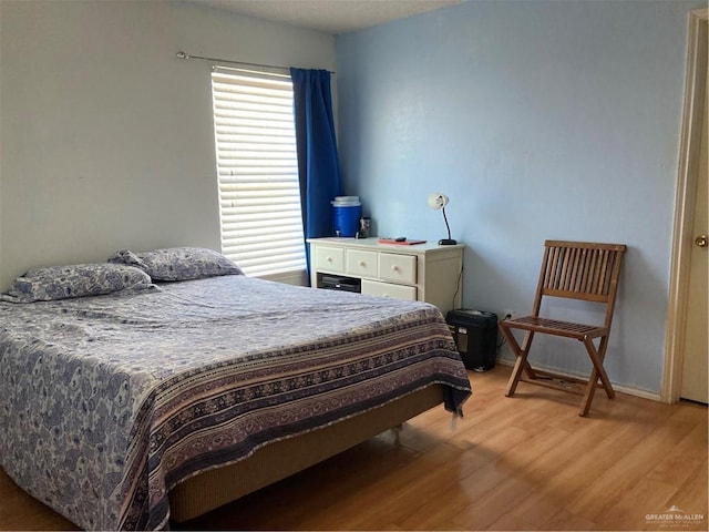 bedroom with hardwood / wood-style floors