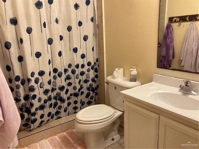 bathroom with tile patterned floors, vanity, toilet, and curtained shower