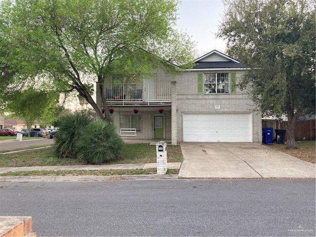 traditional-style house with a garage, brick siding, concrete driveway, and a balcony