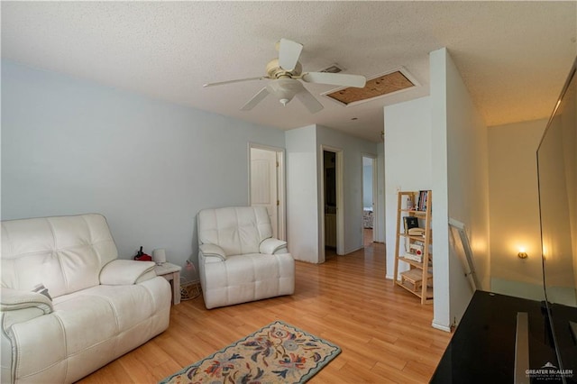 3301 Princeton Ave, Mcallen, TX 78504 - living room featuring a ceiling fan, light wood-style flooring, and a textured ceiling