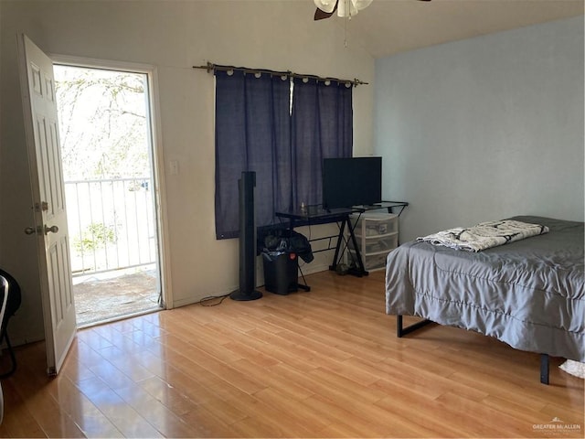 bedroom featuring access to exterior, hardwood / wood-style floors, and ceiling fan