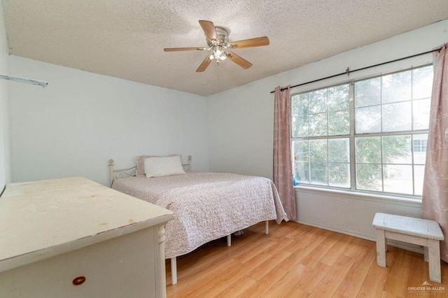 3301 Princeton Ave, Mcallen, TX 78504 - bedroom featuring light wood-style floors, a textured ceiling, baseboards, and ceiling fan