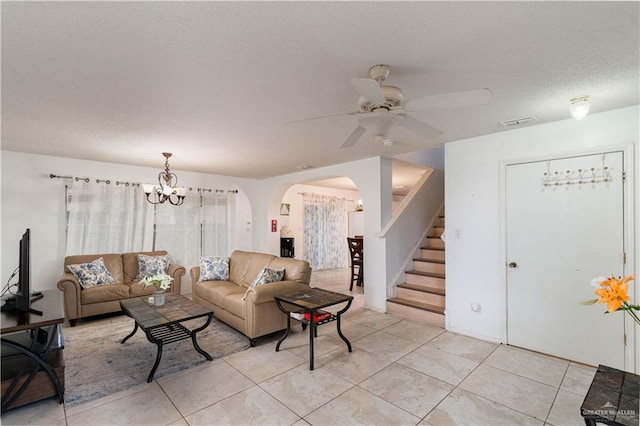 3301 Princeton Ave, Mcallen, TX 78504 - living area with ceiling fan, stairway, arched walkways, a textured ceiling, and light tile patterned floors