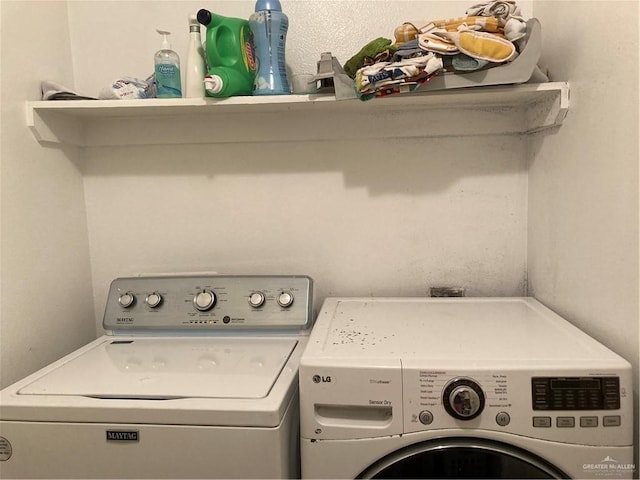 laundry area with washing machine and clothes dryer