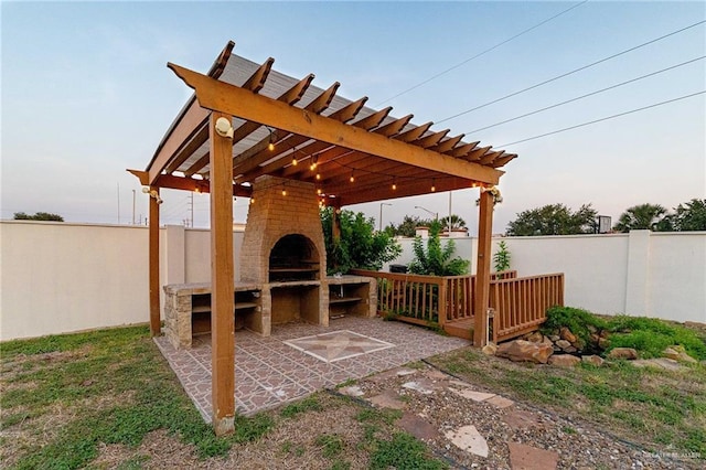 3909 S M St, Mcallen, TX 78503 - fenced backyard with a fireplace, a pergola, and a patio