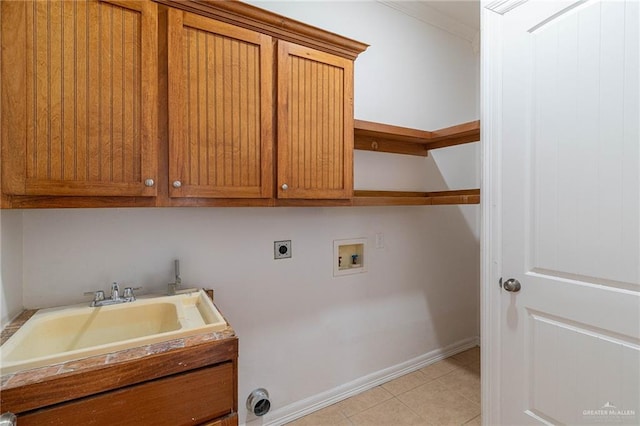 3909 S M St, Mcallen, TX 78503 - laundry room featuring electric dryer hookup, cabinet space, hookup for a washing machine, light tile patterned floors, and baseboards