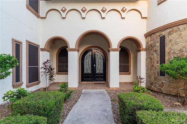 3909 S M St, Mcallen, TX 78503 - doorway to property featuring stone siding and stucco siding