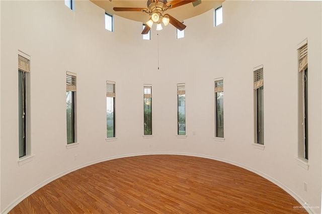 3909 S M St, Mcallen, TX 78503 - empty room featuring a high ceiling, ceiling fan, plenty of natural light, and wood finished floors