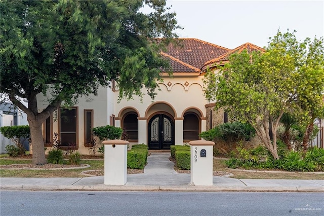 3909 S M St, Mcallen, TX 78503 - mediterranean / spanish-style home featuring french doors, stucco siding, and a tiled roof