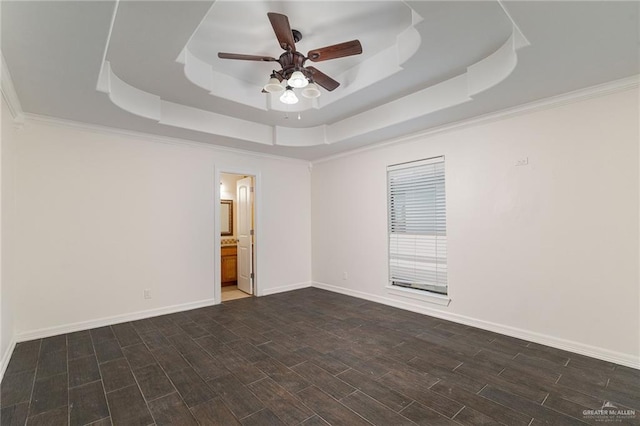 3909 S M St, Mcallen, TX 78503 - spare room featuring a tray ceiling, ceiling fan, wood tiled floors, and baseboards