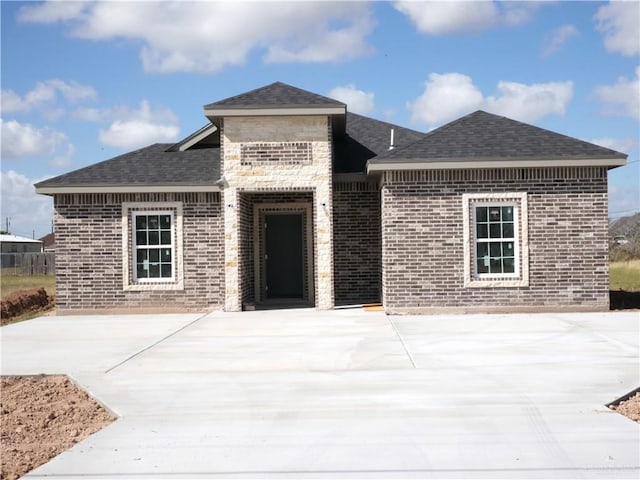 12517 Mile 2 W, Weslaco, TX 78599 - view of front of house featuring brick siding and roof with shingles