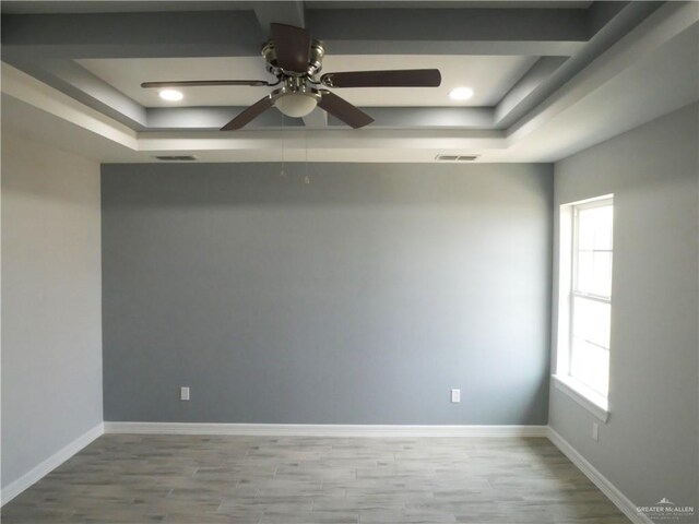 12517 Mile 2 W, Weslaco, TX 78599 - empty room with a tray ceiling, plenty of natural light, a ceiling fan, and recessed lighting