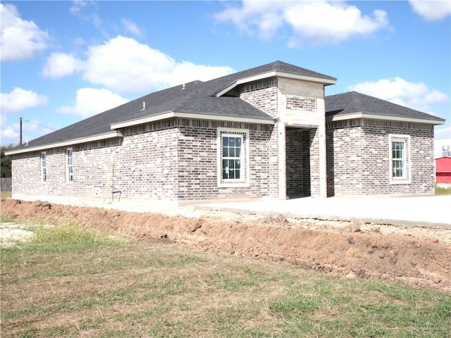 12517 Mile 2 W, Weslaco, TX 78599 - rear view of property with brick siding and a patio
