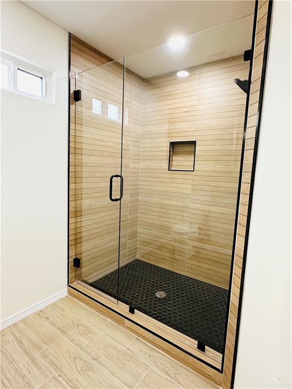 bathroom with a shower with shower door