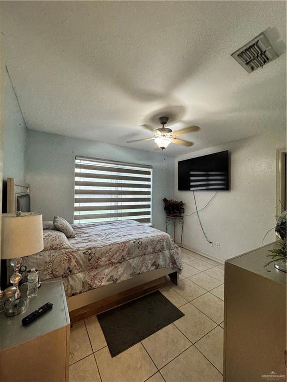 704 S 17th St, Hidalgo, TX 78557 - bedroom featuring light tile patterned flooring, a textured ceiling, and ceiling fan