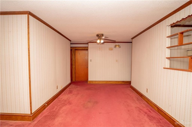 carpeted spare room with a textured ceiling, ceiling fan, and ornamental molding