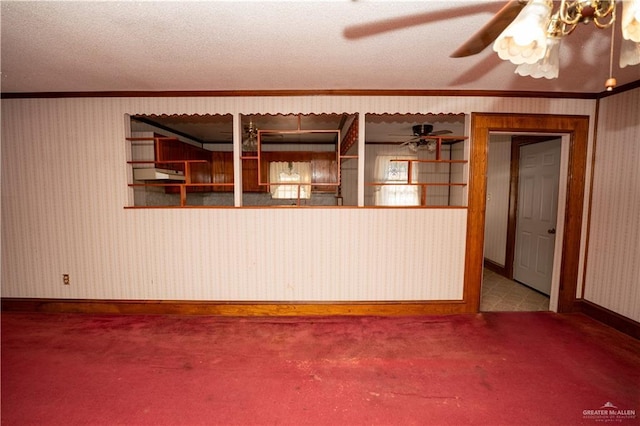 spare room with ornamental molding and a textured ceiling