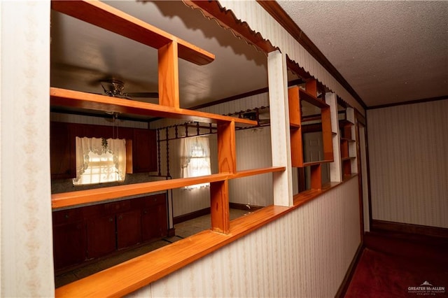 501 N Park Ave, Pharr, TX 78577 - hallway featuring ornamental molding, wallpapered walls, a textured ceiling, and carpet