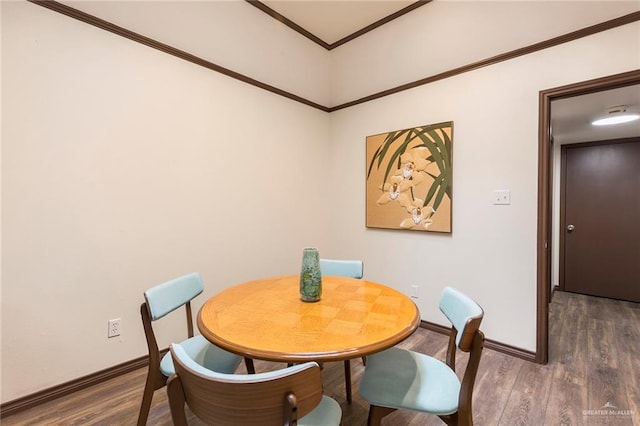 dining room with dark hardwood / wood-style floors and ornamental molding