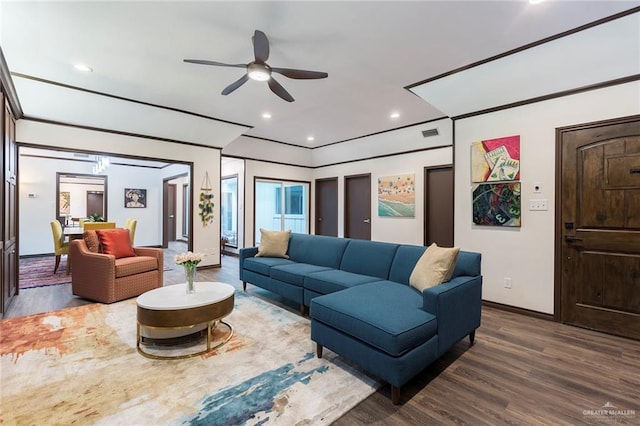 living room with ceiling fan and dark hardwood / wood-style flooring