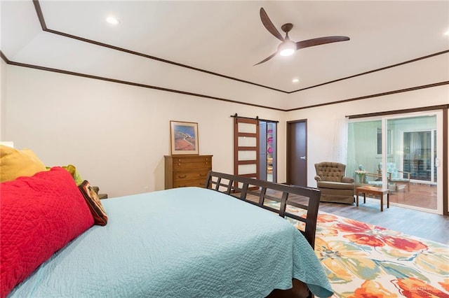 bedroom with ceiling fan, wood-type flooring, and access to outside