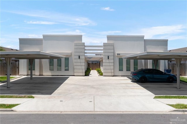 3808 Bella Costa Dr, Weslaco, TX 78596 - modern home with covered parking, stucco siding, and fence