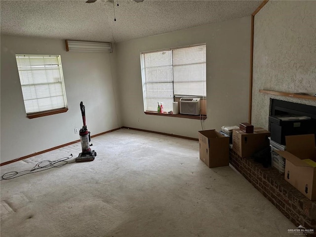 unfurnished living room with cooling unit, ceiling fan, light carpet, and a textured ceiling