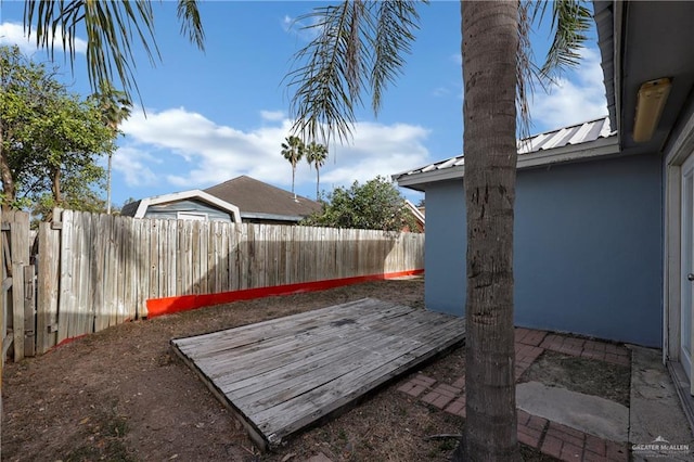 view of yard with a fenced backyard and a deck