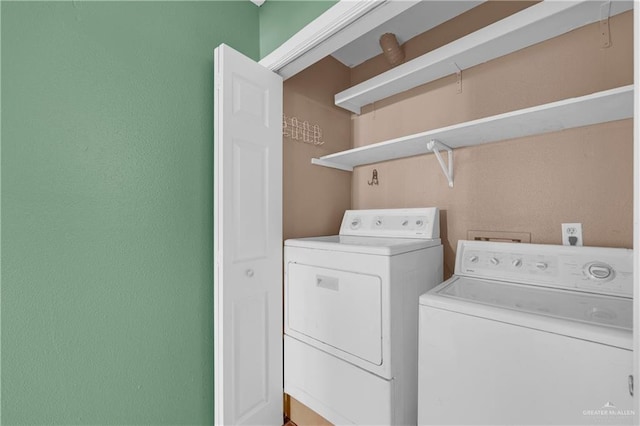 laundry room with laundry area and washing machine and clothes dryer