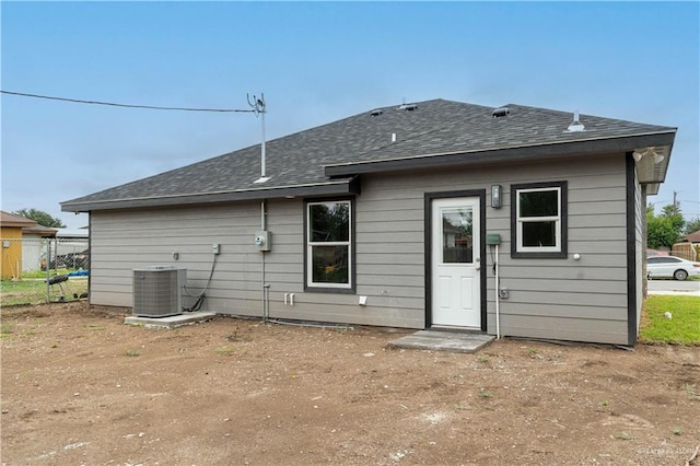 back of house featuring cooling unit